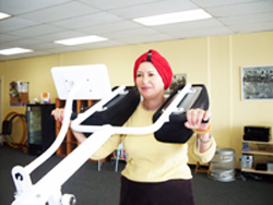 A woman exercising with weights at Curves