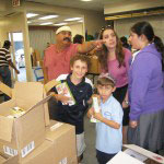 Local people helping to pack food for Tomchei Shabbas
