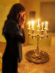 An Agunah lighting her Shabbas Candles & hoping to receive a Jewish Divorce