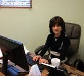 Ruchie working on her computer in her office