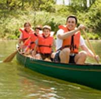 Family canoeing with lifejackets on