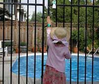 A child at the pool gate