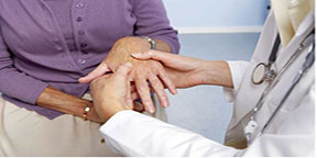Doctor checking Woman's hands to see if she has Rheumatoid Arthritis