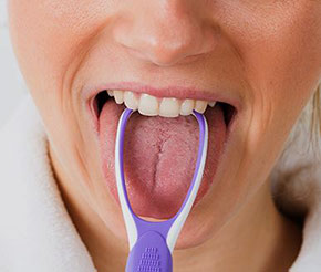 A Woman cleaning her tongue