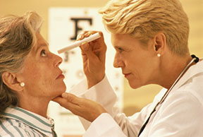 A doctor giving a woman an eye check up